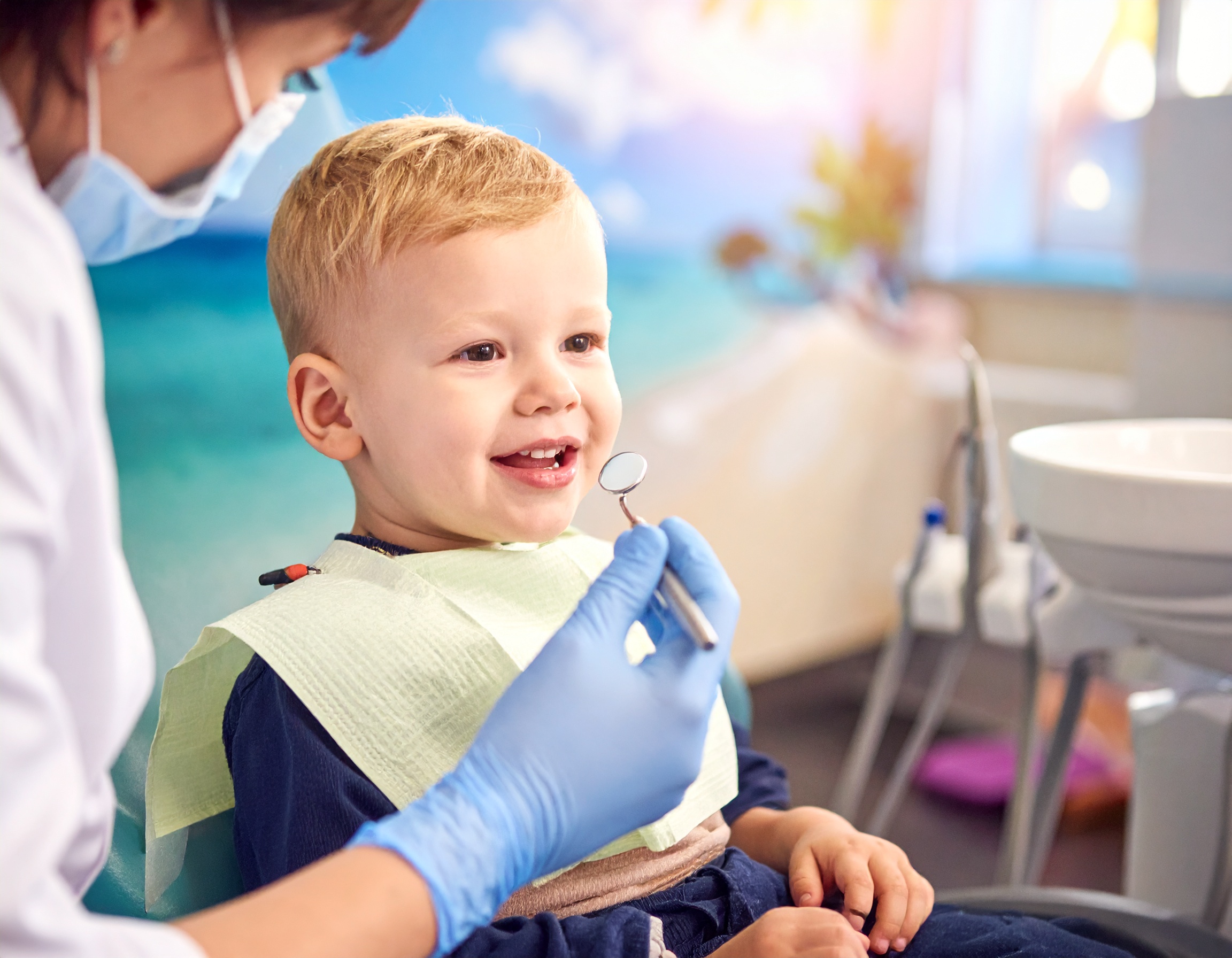 Toddler smiling during first dental visit at pediatric dentist in Temple, Texas